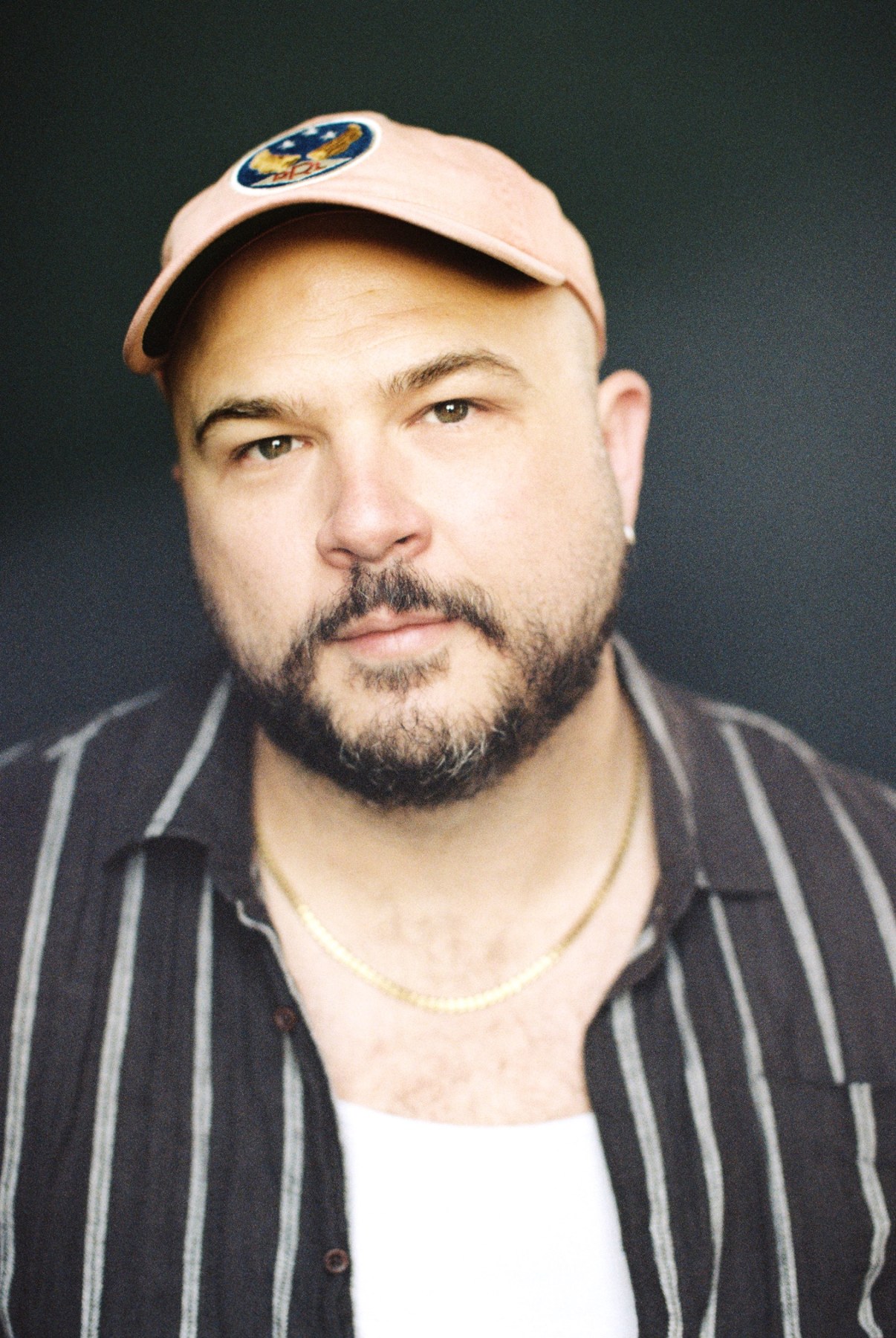 Taylor Harris in a striped shirt and cap