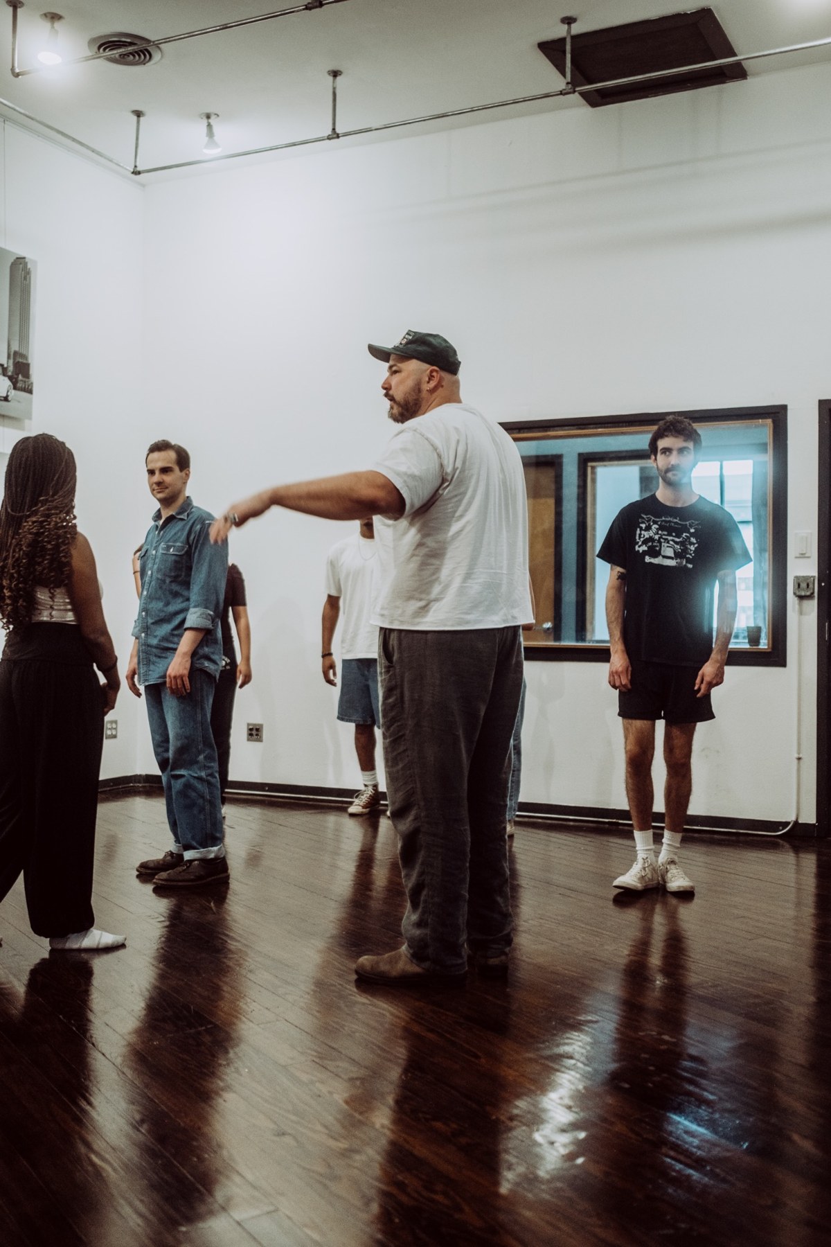 Taylor guiding an ensemble exercise in an acting studio